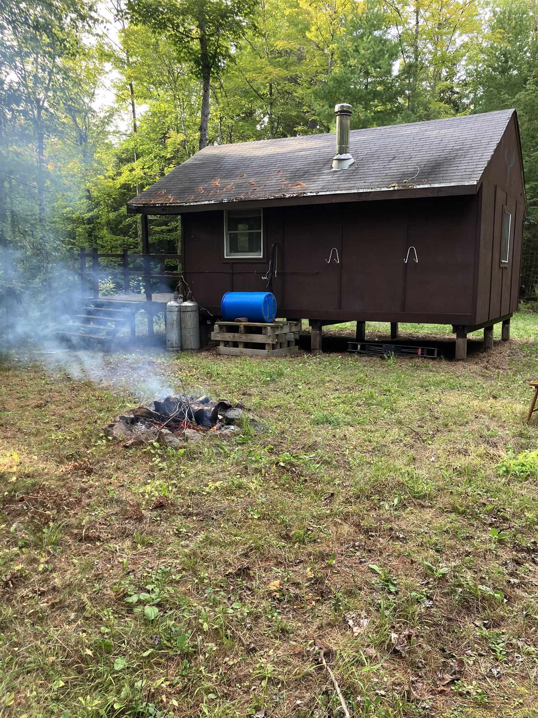 44890 Potato River Road Saxon, WI 54559 - Photo 2 of 16 Back of property featuring heating fuel and a yard