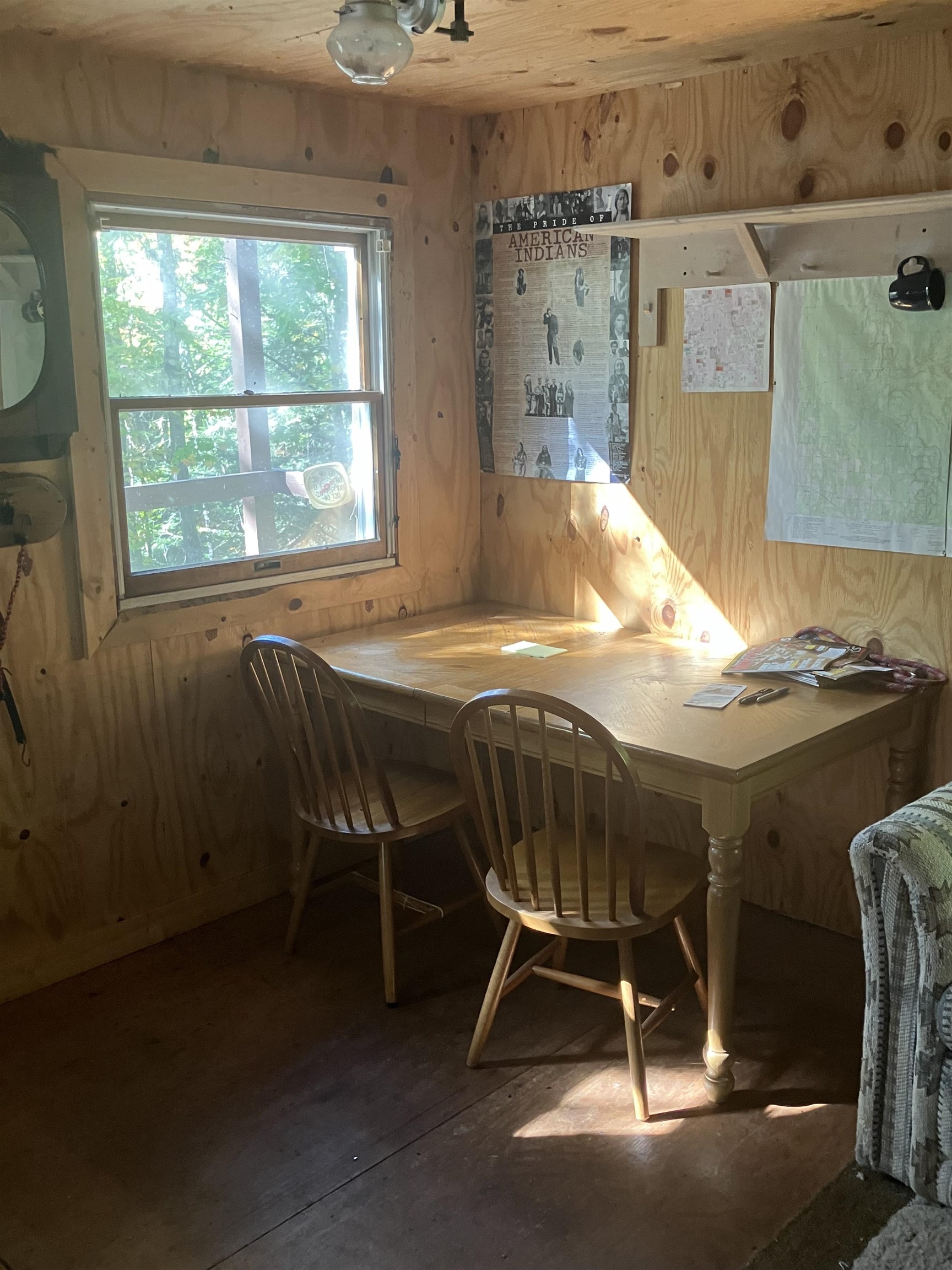 44890 Potato River Road Saxon, WI 54559 - Photo 8 of 16 Dining room featuring wood walls and concrete flooring