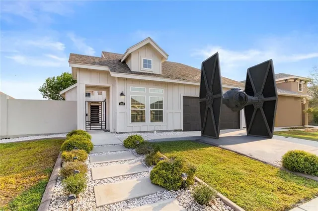 a front view of a house with garden