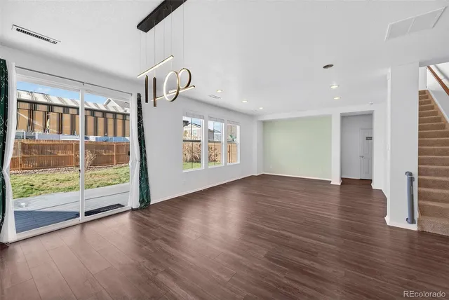 wooden floor in an empty room with a window and wooden floor