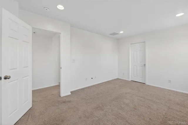 a bathroom with a toilet sink vanity and mirror