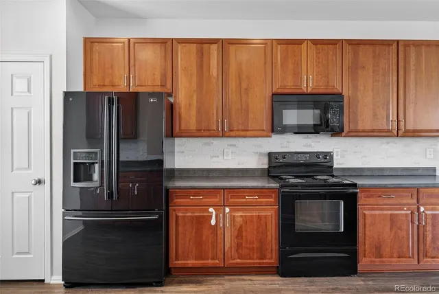 a kitchen with stainless steel appliances granite countertop a stove and a sink