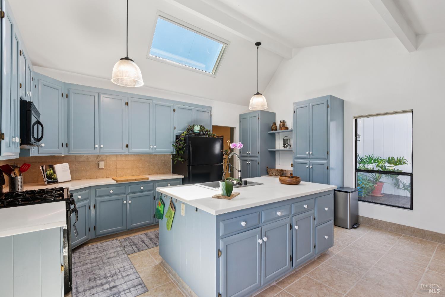 1475 Los Olivos Road Santa Rosa, CA 95404 - Photo 17 of 51 a kitchen that has a lot of cabinets in it and wooden floors