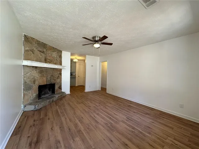 wooden floor in an empty room with a fireplace
