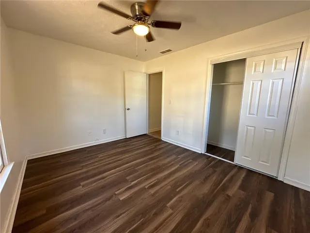 a view of an empty room and wooden floor