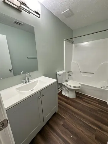 a bathroom with a sink toilet a mirror and shower