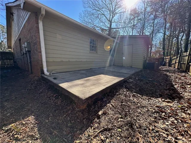 a wooden bench sitting in middle of a yard