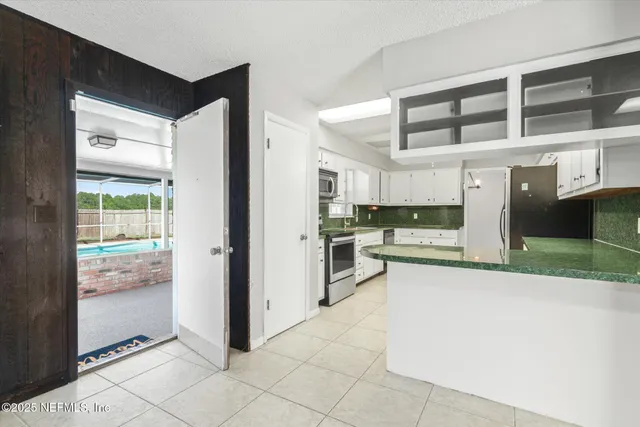 a view of a kitchen with a sink and cabinets