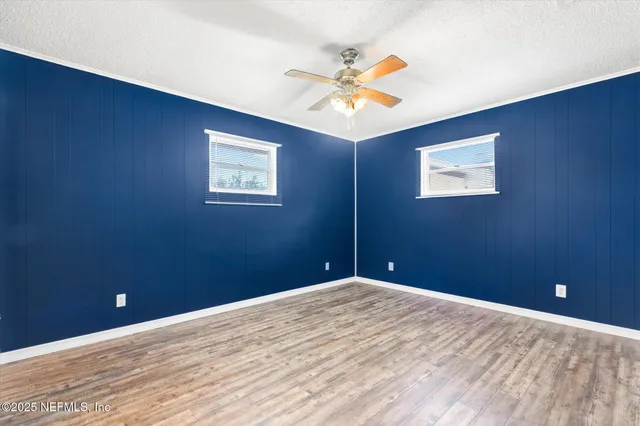 a view of a big room with a ceiling fan and fan