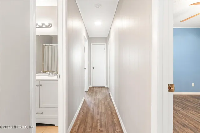a view of a hallway with wooden floor