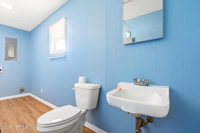 a bathroom with a sink a mirror and a toilet
