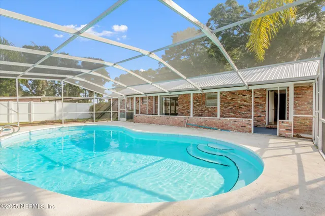 a view of swimming pool with outdoor seating