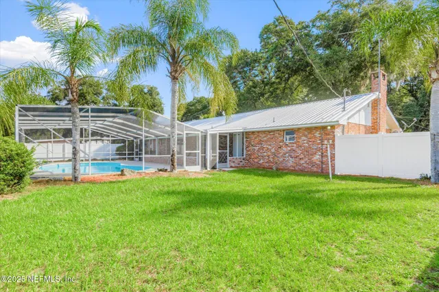 a view of a house with a backyard porch and sitting area