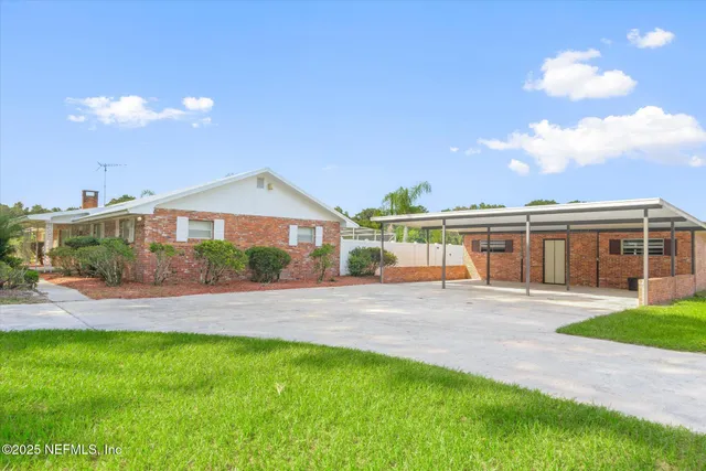 a view of yard with swimming pool and green space