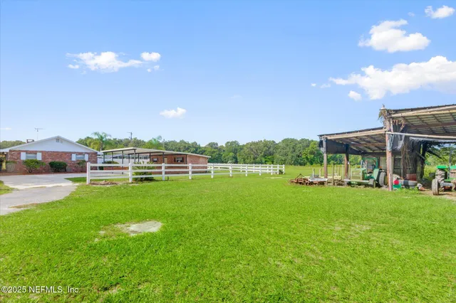 a view of a green field with an ocean