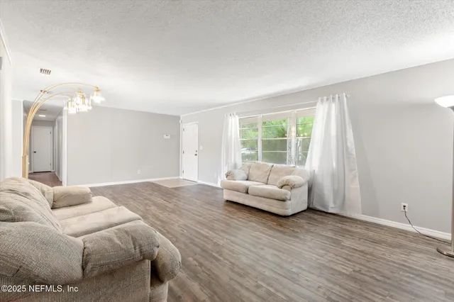 a spacious bedroom with a bed and couch