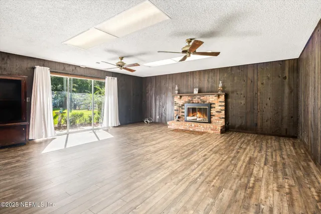 a view of a room with wooden floor garden view and a window