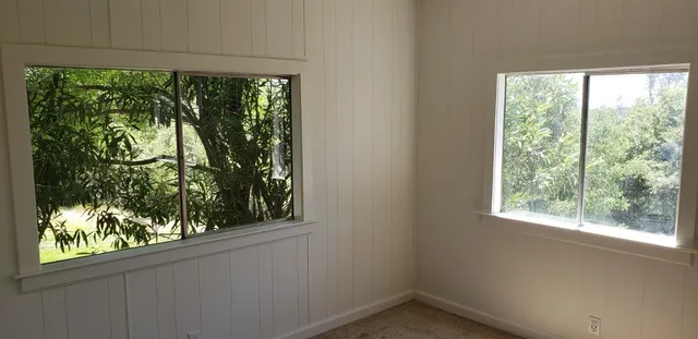 a white house with a small yard