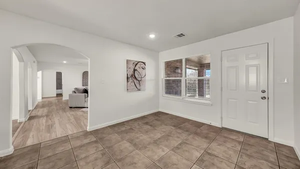 a view of livingroom with hardwood floor and a large window