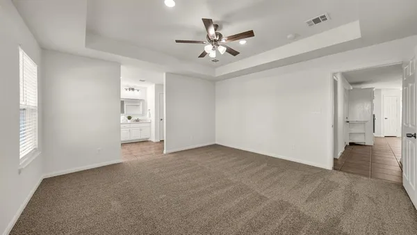 wooden floor in an empty room and a ceiling fan window