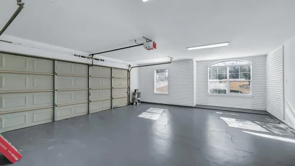 an empty room with windows and entrance