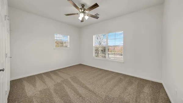 a kitchen with white cabinets and sink