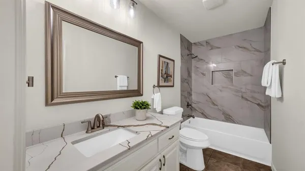 a view of an empty room with wooden floor and a floor to ceiling window