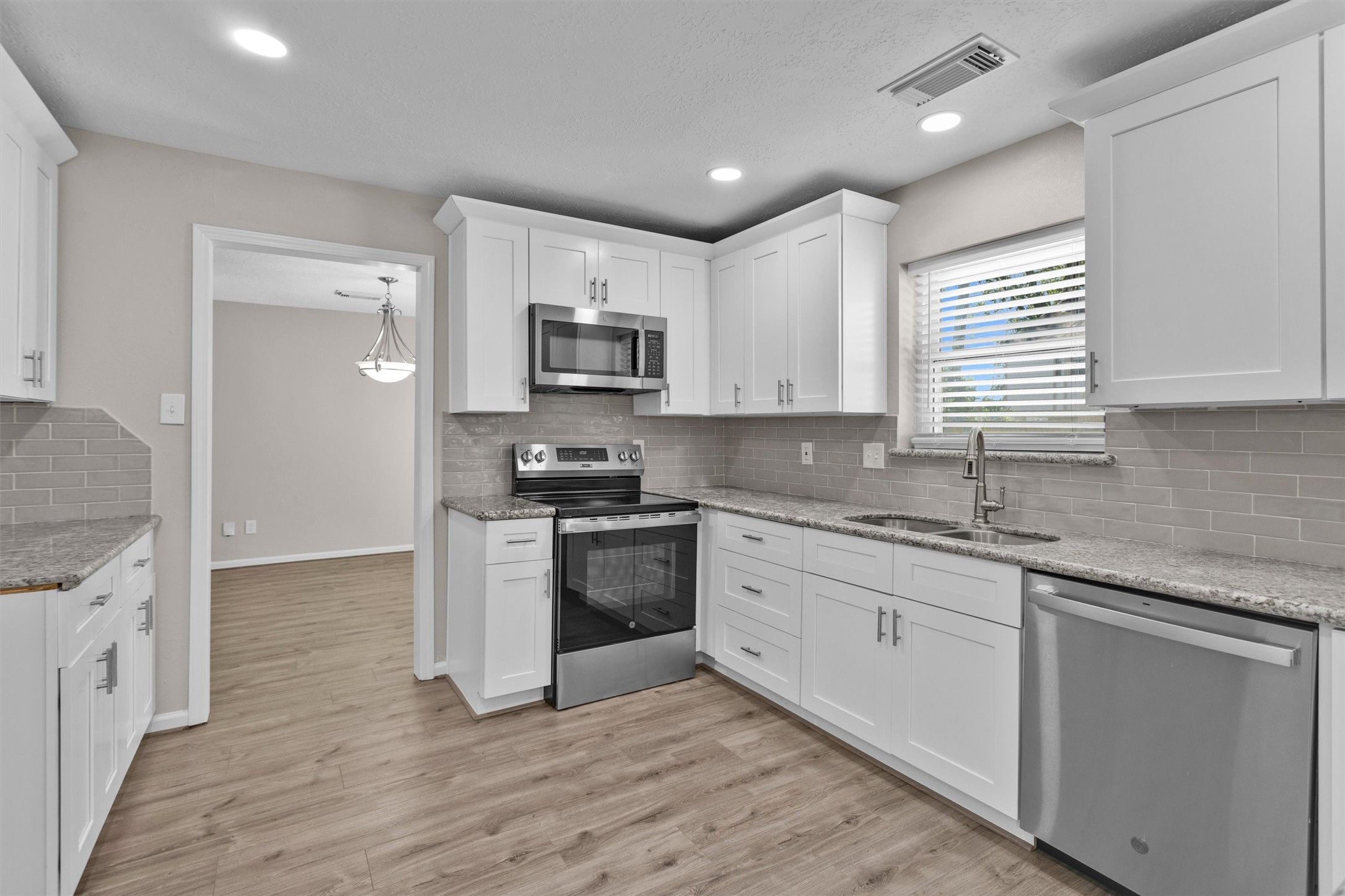 9115 Godstone Lane Spring, TX 77379 - Photo 12 of 46 This kitchen dazzles with sleek granite countertops and modern stainless steel appliances, creating the perfect blend of style and functionality.