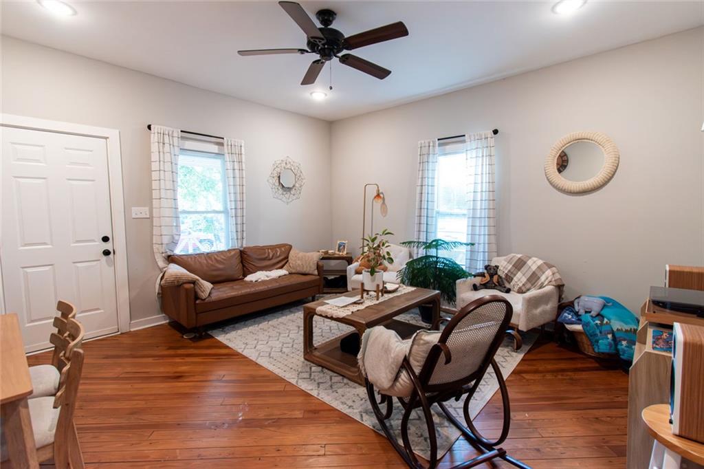 702 Radford Street Monroe, GA 30655 - Photo 6 of 49 a living room with furniture a window and wooden floor