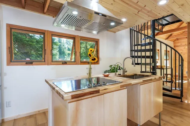 a kitchen that has a sink and a stove