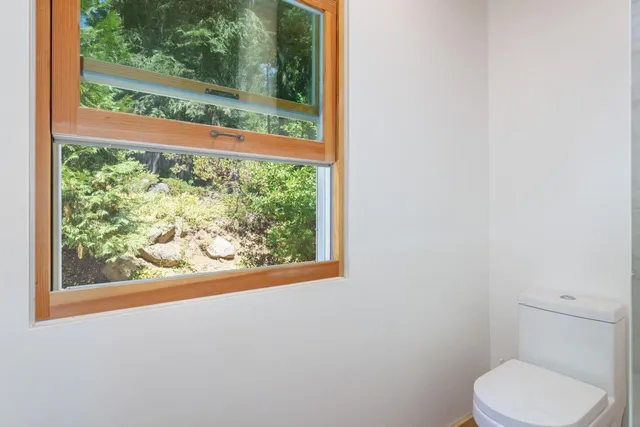 a view of a bedroom with wooden floor and stairs