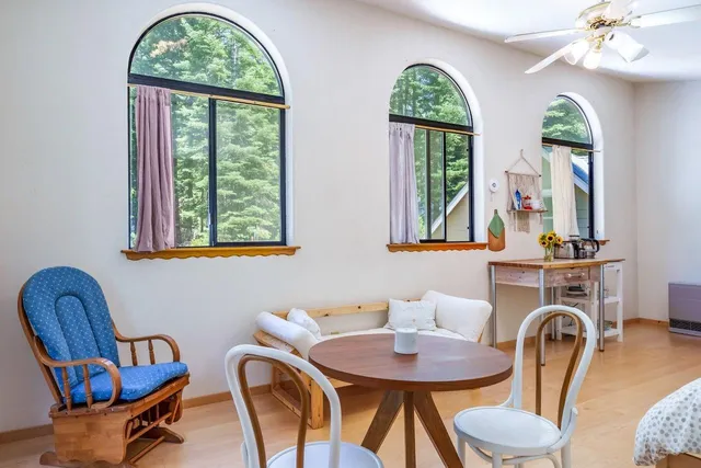 a bedroom with furniture and a large window