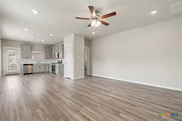a view of kitchen with wooden floor and window
