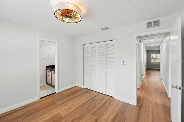 a view of a room with wooden floor