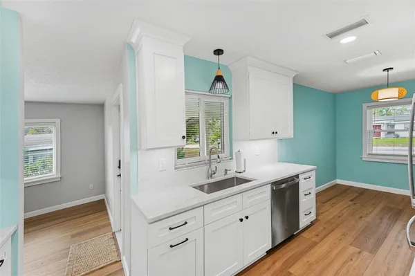 a spacious bathroom with 2 sink and a mirror