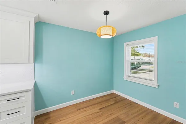 a view of a room that has a window and wooden floor