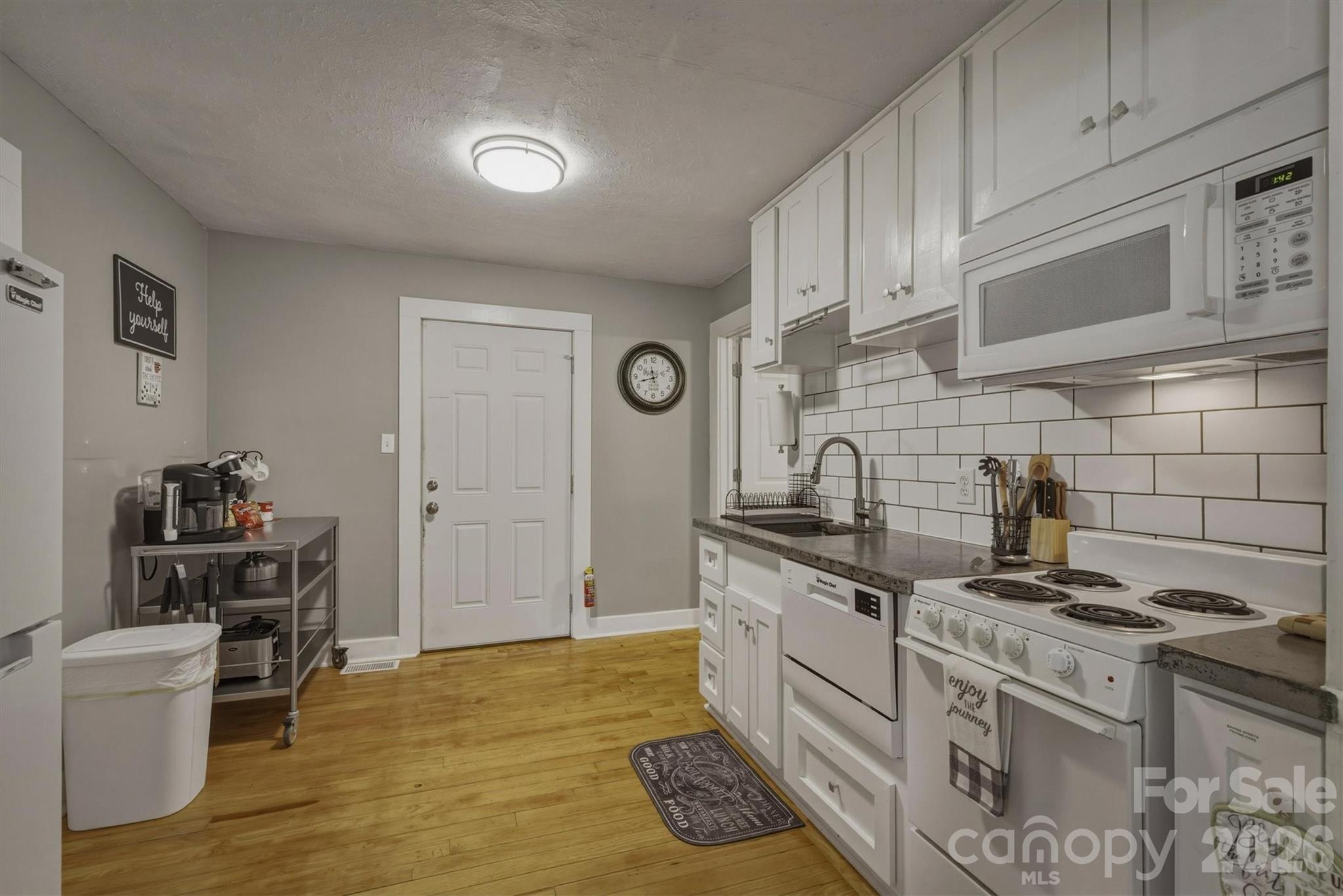 905 Carbon City Road Morganton, NC 28655 - Photo 20 of 29 a kitchen with stainless steel appliances granite countertop a stove a sink and a refrigerator
