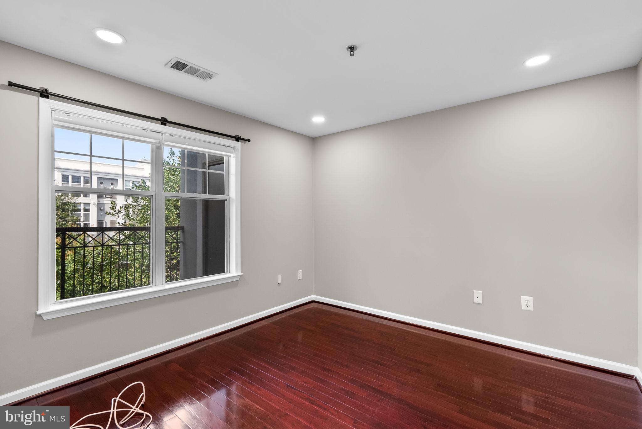5563 Seminary Road, Unit 302 Falls Church, VA 22041 - Photo 17 of 30 a view of an empty room with wooden floor and a window
