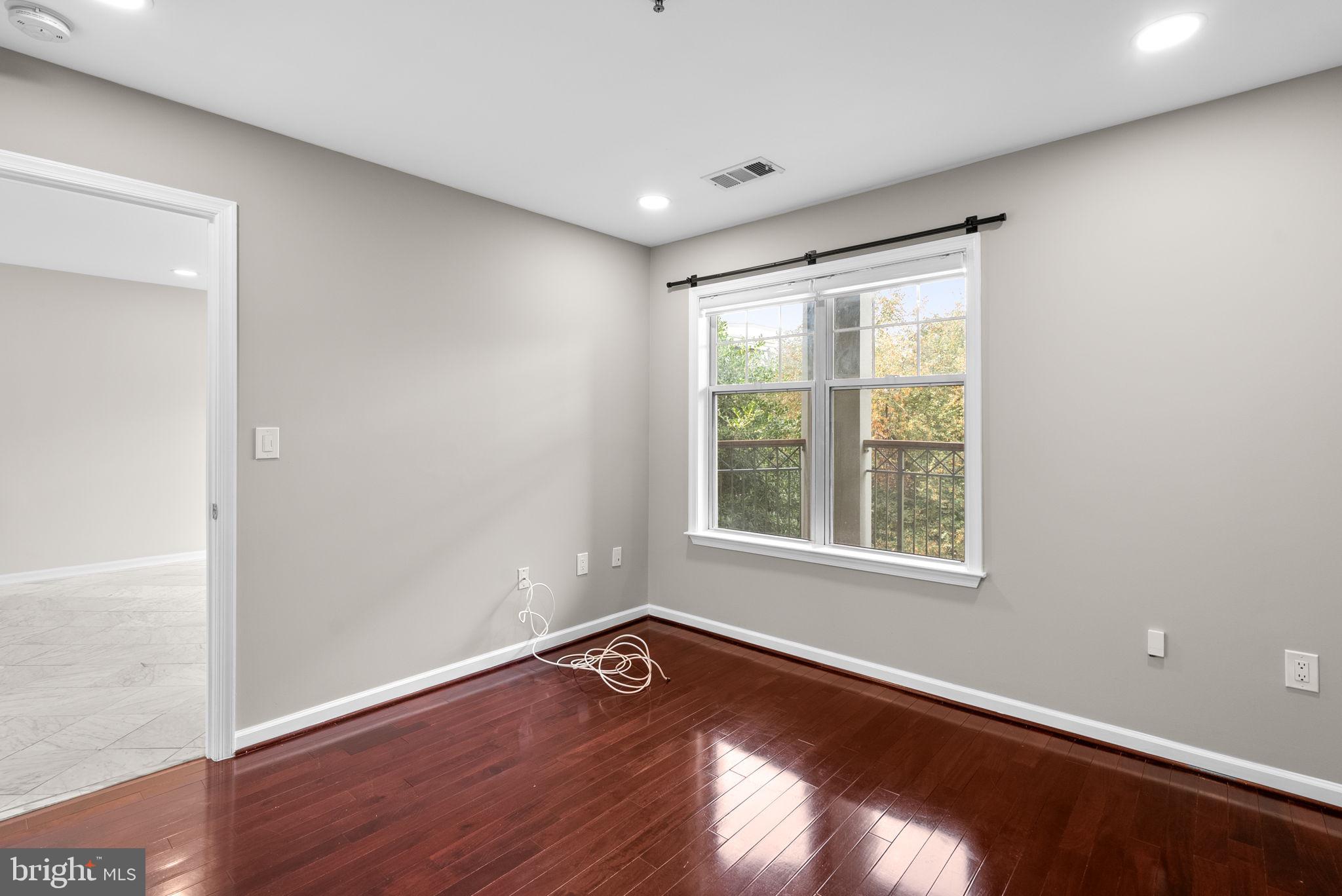 5563 Seminary Road, Unit 302 Falls Church, VA 22041 - Photo 19 of 30 an empty room with wooden floor and windows
