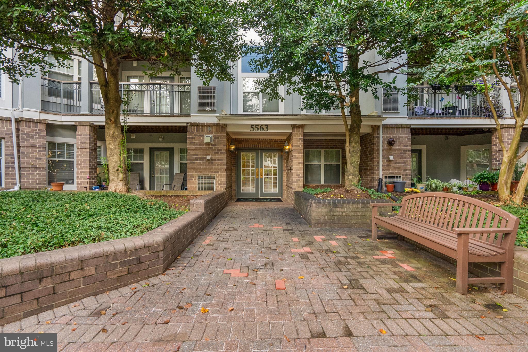 5563 Seminary Road, Unit 302 Falls Church, VA 22041 - Photo 4 of 30 a front view of a house with a garden and trees