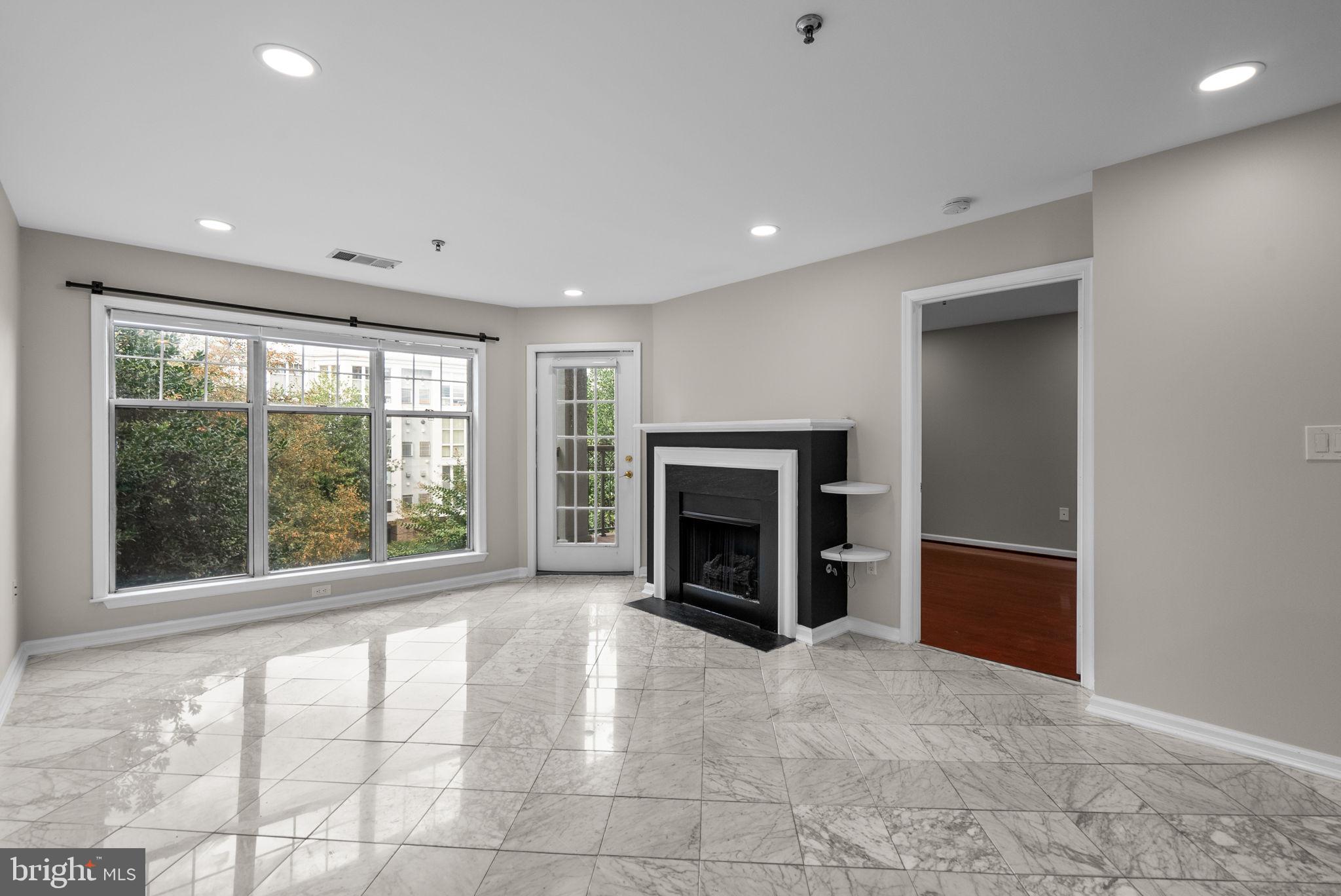 5563 Seminary Road, Unit 302 Falls Church, VA 22041 - Photo 8 of 30 a view of an empty room with a window and a fireplace