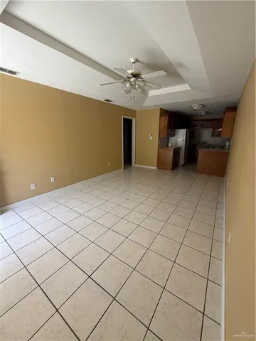 a view of a livingroom and a chandelier fan