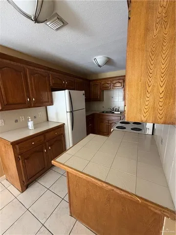 a kitchen with stainless steel appliances a refrigerator and a stove top oven