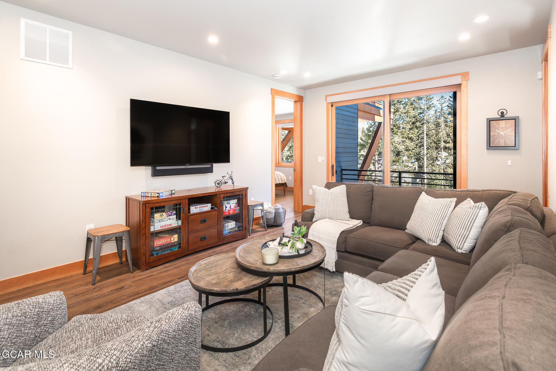 684 Vasquez Road Winter Park, CO 80482 - Photo 35 of 45 a living room with furniture a flat screen tv and a large window