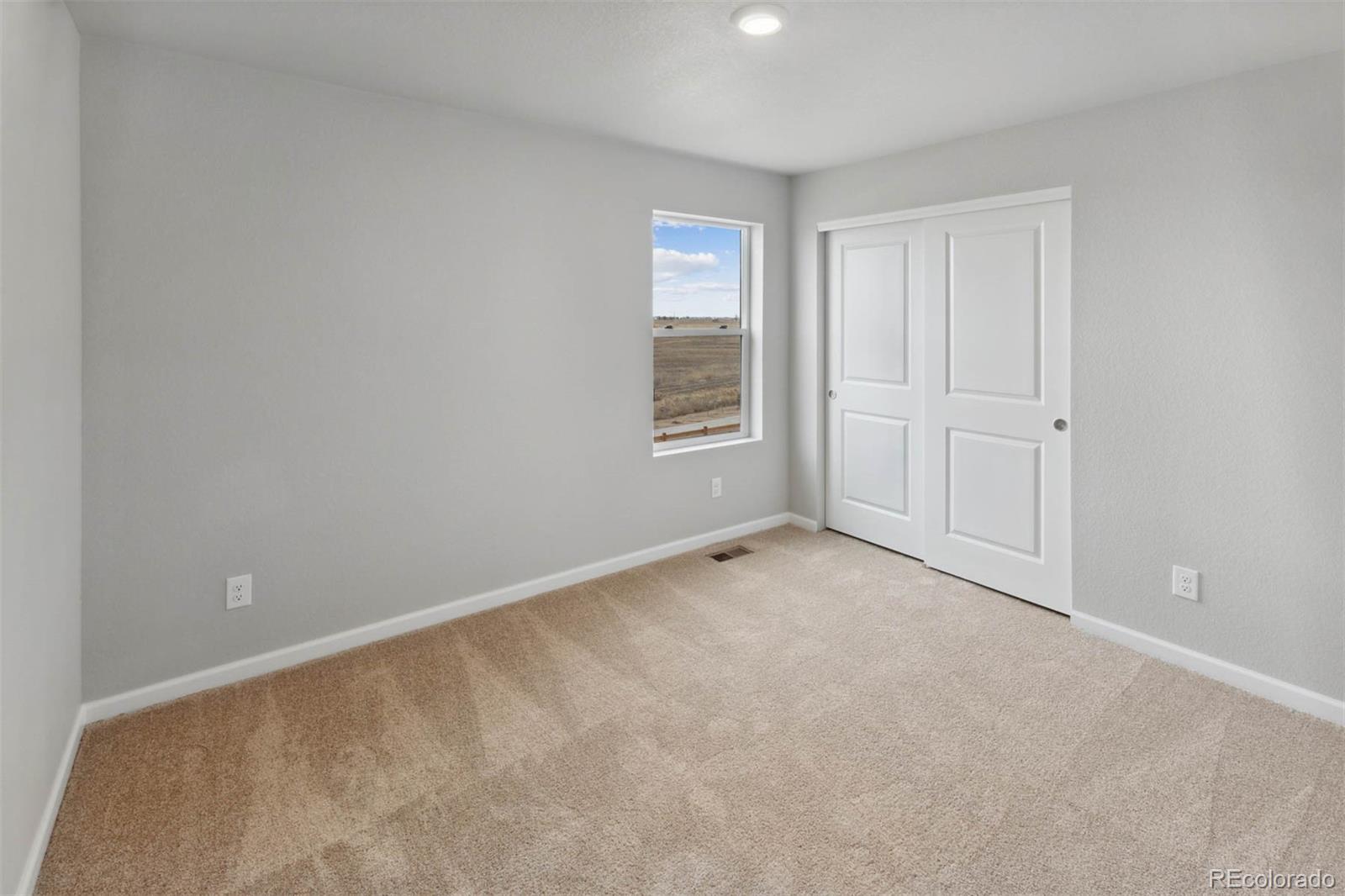 2125 Alyssa Street Fort Lupton, CO 80621 - Photo 14 of 39 a view of an empty room with a window