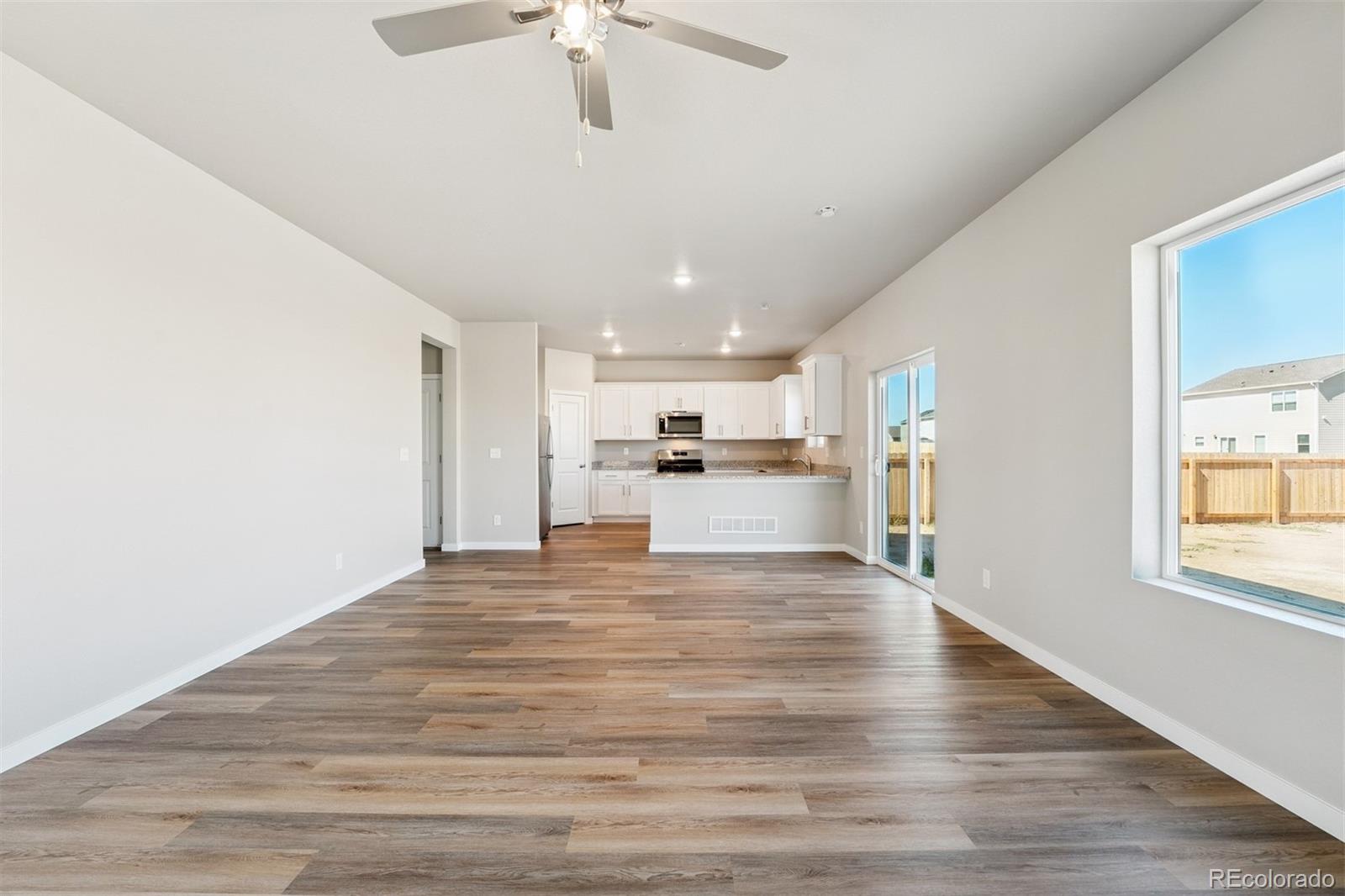 2125 Alyssa Street Fort Lupton, CO 80621 - Photo 6 of 39 a view of kitchen with wooden floor