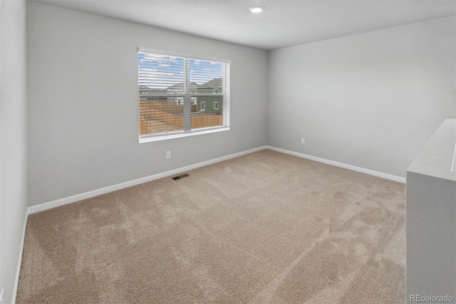 2125 Alyssa Street Fort Lupton, CO 80621 - Photo 8 of 39 an empty room with windows
