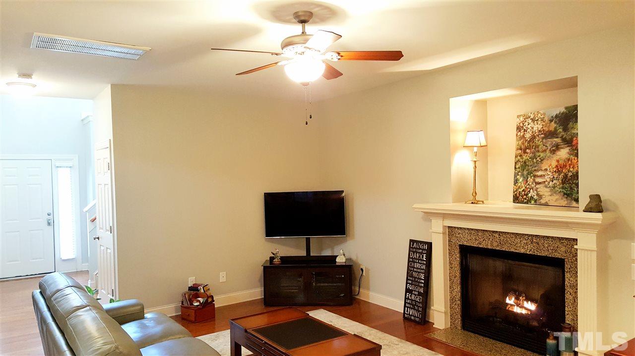 138 Tramway Circle Angier, NC 27501 - Photo 3 of 26 a living room with furniture a fireplace and a flat screen tv