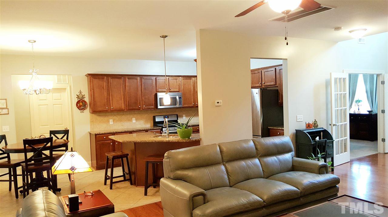 138 Tramway Circle Angier, NC 27501 - Photo 4 of 26 a living room with furniture kitchen view and a wooden floor