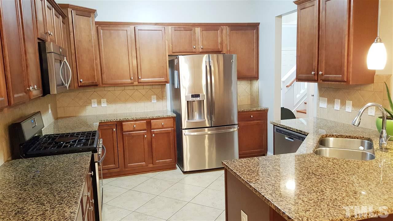 138 Tramway Circle Angier, NC 27501 - Photo 6 of 26 a kitchen with stainless steel appliances granite countertop a refrigerator a stove and a sink